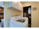 Laundry area with a washing machine, dryer, overhead cabinets, and tile flooring at 506 S Green St, Brownsburg, IN 46112