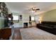 Cozy living room features a fireplace, built-in shelving, and a ceiling fan at 506 S Green St, Brownsburg, IN 46112