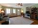 Bright and airy living room features hardwood floors, comfortable seating, and backyard views at 506 S Green St, Brownsburg, IN 46112