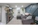 Finished basement with a gray sectional sofa, modern fireplace, and decorative wall paneling at 5119 Ralston Ave, Indianapolis, IN 46205