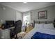 Bedroom with a desk, a comfortable bed, and a window, perfect for relaxing and enjoying natural light at 5119 Ralston Ave, Indianapolis, IN 46205