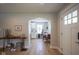 Open entryway view, flowing into the dining area and kitchen, with beautiful hardwood floors and modern decor at 5119 Ralston Ave, Indianapolis, IN 46205