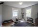 Bright workout area with exercise equipment and natural light from two windows at 5119 Ralston Ave, Indianapolis, IN 46205