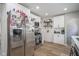 Bright kitchen featuring white cabinets, stainless steel appliances, and stylish wood-look flooring at 5119 Ralston Ave, Indianapolis, IN 46205