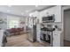 Eat-in kitchen with stainless steel appliances, white cabinets, and an adjacent dining area with bright light at 5119 Ralston Ave, Indianapolis, IN 46205