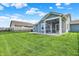 Exterior showcasing a screened-in porch, a well-maintained lawn, and a fenced yard for private outdoor living at 5248 Holborn Ave, McCordsville, IN 46055