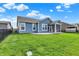 Expansive backyard featuring a well-manicured lawn, privacy fence, and a screened-in porch for outdoor enjoyment at 5248 Holborn Ave, McCordsville, IN 46055