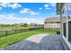 Spacious backyard with stamped concrete patio, lush lawn, and a black fence with a view of a pond at 5248 Holborn Ave, McCordsville, IN 46055