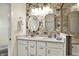Charming bathroom featuring double vanity, round mirrors, floral wallpaper, and glass-enclosed tiled shower at 5248 Holborn Ave, McCordsville, IN 46055
