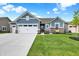 Charming single-Gathering home featuring blue siding, well-maintained landscaping, and a spacious three-car garage at 5248 Holborn Ave, McCordsville, IN 46055