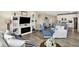 Open-concept living area featuring hardwood floors, a custom entertainment center, and a modern fireplace at 5248 Holborn Ave, McCordsville, IN 46055