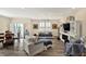 Bright and open living room with hardwood floors, comfortable seating, and access to outdoor patio at 5248 Holborn Ave, McCordsville, IN 46055