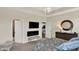 Main bedroom with a trey ceiling, chandelier, television, and seating bench at 5248 Holborn Ave, McCordsville, IN 46055