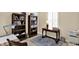 Bright home office featuring bookshelves, a desk, and a window with natural light at 5248 Holborn Ave, McCordsville, IN 46055