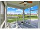 Relaxing screened-in patio with decorative floor offers scenic views of the community pond at 5248 Holborn Ave, McCordsville, IN 46055