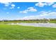 Picturesque view of the community pond with lush green surroundings creating a peaceful, relaxing environment at 5248 Holborn Ave, McCordsville, IN 46055