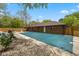 Backyard with a covered pool, fenced perimeter, and lush green trees at 5312 Larita Ln, Anderson, IN 46017