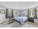 Bright bedroom with a blue quilt bed, carpeted floors, and natural light from the windows at 5312 Larita Ln, Anderson, IN 46017