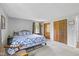 Bedroom featuring a bed with a blue quilt, carpeted floors, and wooden closet doors at 5312 Larita Ln, Anderson, IN 46017