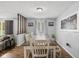 Dining area featuring wood floors, large windows, and a stylish wooden table with seating at 5312 Larita Ln, Anderson, IN 46017