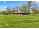 Expansive, well-maintained lawn and charming brick ranch-style home offer comfortable living in a serene setting at 5312 Larita Ln, Anderson, IN 46017