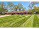 Charming ranch-style home with a manicured lawn, mature trees and attached two-car garage at 5312 Larita Ln, Anderson, IN 46017