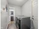 Laundry room equipped with new washer and dryer, wooden-like floor, and white door at 5312 Larita Ln, Anderson, IN 46017