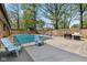 Outdoor pool and patio area surrounded by a wooden fence and mature trees. Includes chairs and gas grill at 5312 Larita Ln, Anderson, IN 46017
