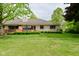 Beautiful backyard featuring a deck, manicured lawn, and brick exterior at 5361 Carnoustie Cir, Avon, IN 46123