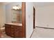 Bathroom featuring a double sink vanity with a granite countertop and a tiled shower at 5361 Carnoustie Cir, Avon, IN 46123