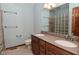 Well-lit bathroom with double sinks, tile flooring, and a glass block shower window at 5361 Carnoustie Cir, Avon, IN 46123