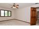 Bedroom features a ceiling fan, window with view and a traditional-style wooden door at 5361 Carnoustie Cir, Avon, IN 46123