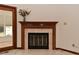 A cozy fireplace is framed by a classic wood mantle, perfect for gatherings at 5361 Carnoustie Cir, Avon, IN 46123