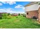 Green backyard, siding and brick exterior and view of houses at 5377 Crooked Stick Ct, Greenwood, IN 46142