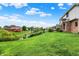 A spacious backyard featuring lush green grass and a brick home exterior at 5377 Crooked Stick Ct, Greenwood, IN 46142