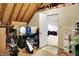 Unfinished basement space with exposed wood rafters, pink insulation, and a doorway to a finished area at 5377 Crooked Stick Ct, Greenwood, IN 46142
