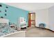 Bright bedroom featuring an accent wall, white furniture, and access to the hallway, offering a tranquil retreat at 5377 Crooked Stick Ct, Greenwood, IN 46142
