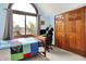 Bright bedroom with an arched window, a comfortable bed, and a workspace, creating an inviting and functional space at 5377 Crooked Stick Ct, Greenwood, IN 46142