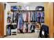 Walk-in closet featuring hanging clothes, shelving, seating and carpet flooring at 5377 Crooked Stick Ct, Greenwood, IN 46142