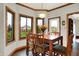 Bright dining room featuring a wood table, seating for six, and scenic backyard views at 5377 Crooked Stick Ct, Greenwood, IN 46142