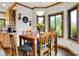 Inviting dining room with wood table, seating, and ample natural light from the windows at 5377 Crooked Stick Ct, Greenwood, IN 46142