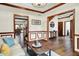 Inviting foyer with hardwood floors, crown molding, and views of dining and staircase at 5377 Crooked Stick Ct, Greenwood, IN 46142