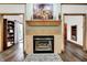 Cozy fireplace with tile surround, decorative mantle, and hardwood flooring at 5377 Crooked Stick Ct, Greenwood, IN 46142