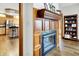 Elegant fireplace featuring wood accents and a view of the nearby kitchen and bookcase at 5377 Crooked Stick Ct, Greenwood, IN 46142