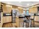 Bright kitchen with light wood cabinets, stainless steel appliances, and island seating at 5377 Crooked Stick Ct, Greenwood, IN 46142