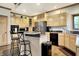 Kitchen with light wood cabinets, stainless steel appliances, and island with granite countertop at 5377 Crooked Stick Ct, Greenwood, IN 46142
