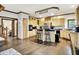 Open kitchen with light wood cabinets, stainless steel appliances, and island seating at 5377 Crooked Stick Ct, Greenwood, IN 46142