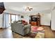 Open living room featuring comfortable sofas, a media cabinet, and natural light at 5377 Crooked Stick Ct, Greenwood, IN 46142