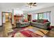 Spacious living room with wood floors, sofas, and open access to the kitchen and dining area at 5377 Crooked Stick Ct, Greenwood, IN 46142