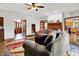Inviting living room with wood floors, cozy furniture, and views into the kitchen and entryway at 5377 Crooked Stick Ct, Greenwood, IN 46142